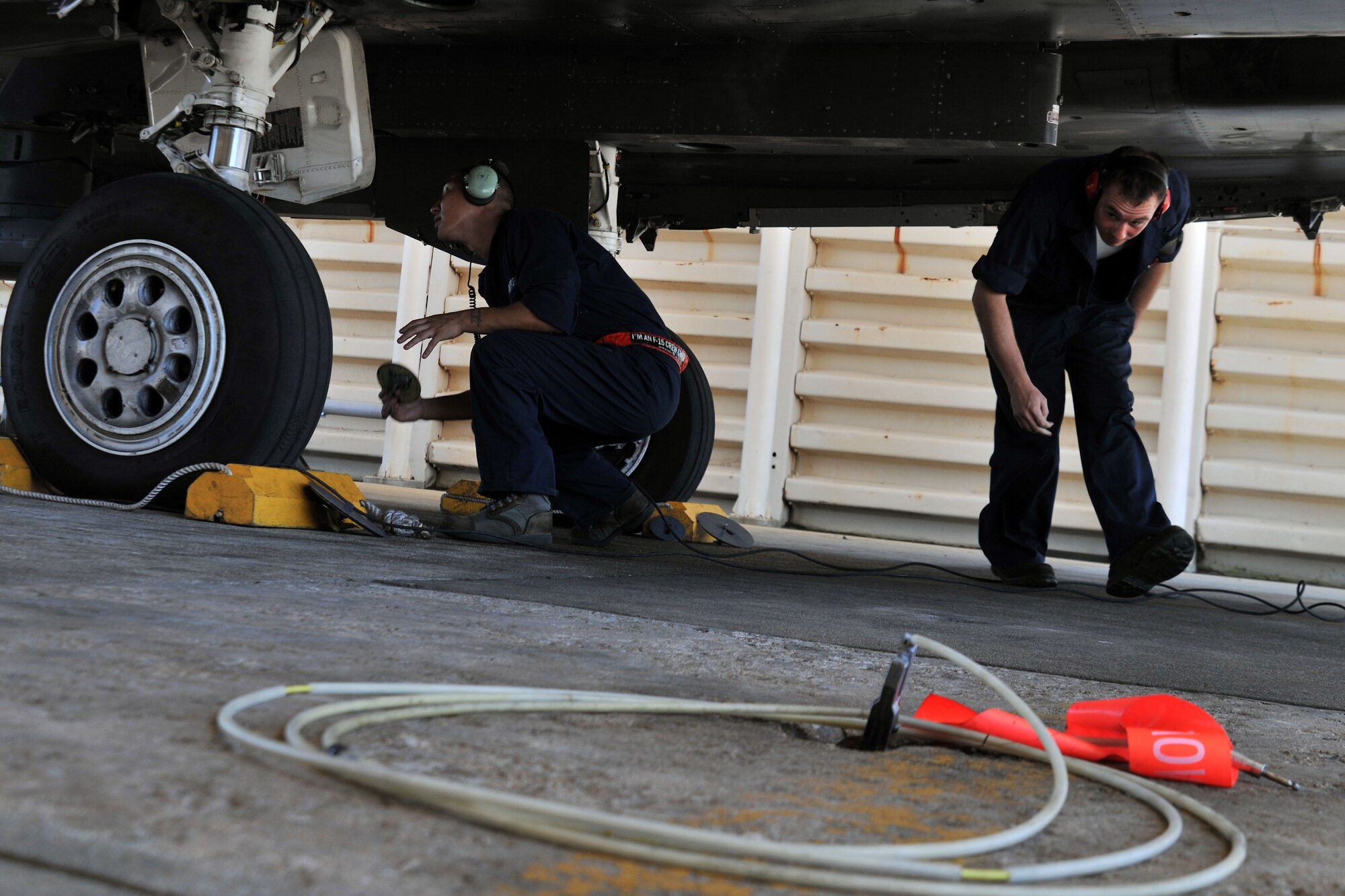 KUNSAN AIR BASE, Republic of Korea -- Senior Airman Dennis Lee and SrA Jacob Spivey, 48th Aircraft Maintenance Squadron crew chiefs perform a pre-flight inspection here Aug. 5. RAF Lakenheath’s 494th Expeditionary Fighter Squadron is currently deployed to Kunsan as part of the theater support package and has been on station for approximately three months. (U.S. Air Force photo/Senior Airman Brittany Y. Bateman)