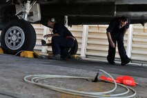 KUNSAN AIR BASE, Republic of Korea -- Senior Airman Dennis Lee and SrA Jacob Spivey, 48th Aircraft Maintenance Squadron crew chiefs perform a pre-flight inspection here Aug. 5. RAF Lakenheath’s 494th Expeditionary Fighter Squadron is currently deployed to Kunsan as part of the theater support package and has been on station for approximately three months. (U.S. Air Force photo/Senior Airman Brittany Y. Bateman)