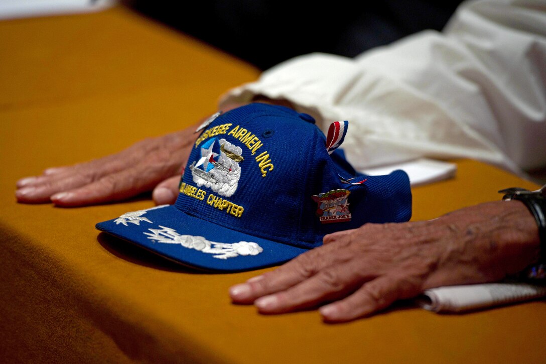 Jerry Hodges, an original member of the Tuskegee Airmen, listens to guest speakers during the opening ceremony of the Tuskegee Airmen's 40th national convention at the Gaylord National Hotel in National Harbor, Md., Aug. 4, 2011. Hodges joined the military on June 12, 1944, and was assigned to the 617th Bomber Squadron, 477th Bomber Group, July 5, 1946.