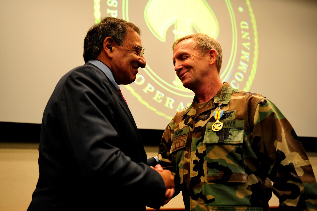 Defense Secretary Leon E. Panetta shakes the hand of Navy Adm. Eric T. Olson, outgoing commander of U.S. Special Operations Command, after presenting him the Defense Distinguished Service Medal before the USSOCOM change of command ceremony at MacDill Air Force Base, Fla., Aug. 8, 2011.