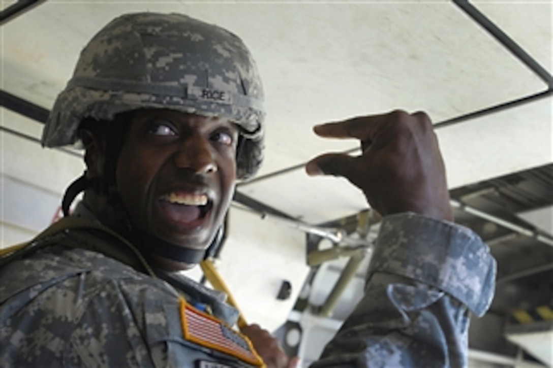 Army Master Sgt. Sean Rice gives the hand signal for "30 seconds" during an airborne operation in a Casa 212 aircraft over St. Mere Eglise drop zone at Fort Bragg, N.C., on Aug. 2, 2011.  The operation was part of the 2011 Rigger Rodeo competition to decide the yearís best parachute rigger in the U.S. Armed Forces.  Rice is an operations sergeant major assigned to the 82nd Sustainment Brigade.  