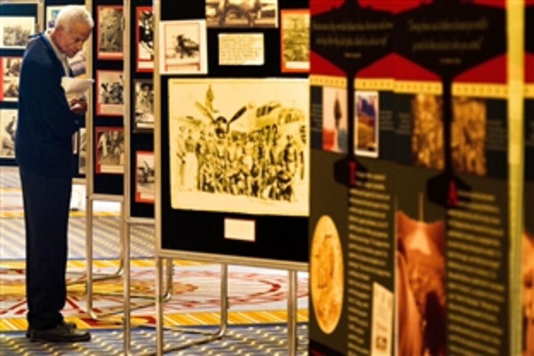 Retired Flight Officer Donald Jackson looks at photos from his former unit, the 477th Bombardment Group, during the Tuskegee Airmen's 40th national convention at Gaylord National Hotel in National Harbor, Md., Aug. 4, 2011. 