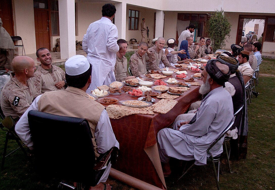 Marines from 1st Battalion, 3rd Marine Regiment and district government officials enjoy Iftar, or ‘breaking of fast,’ which is the nightly meal during the month-long Islamic holiday Ramadan, Aug. 8. Marines from 1/3 are regularly invited to Iftar with their Afghan National Army and Police counterparts during Ramadan.