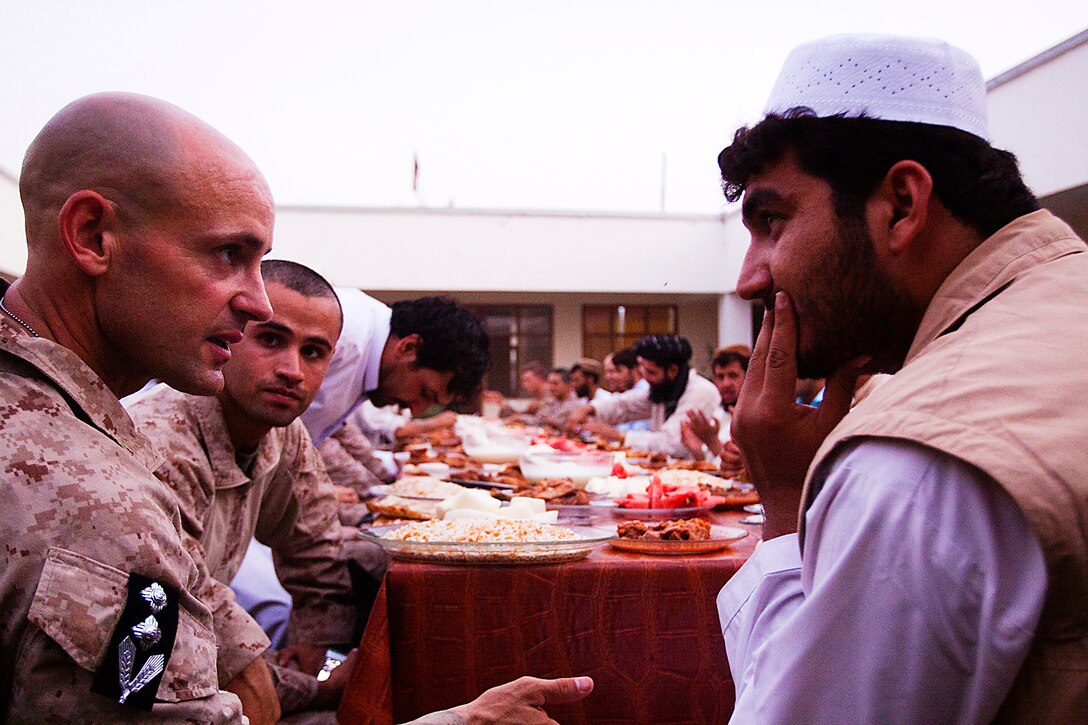 Lt. Col. Sean Riordan speaks with District Governor Mohammed Fahim during Iftar, or ‘breaking of fast,’ which is the nightly meal during the month-long Islamic holiday Ramadan, Aug. 8. Riordan, a native of Montclair, Va., is the commanding officer of 1st battalion, 3rd Marines. Marines from 1/3 are regularly invited to Iftar with their Afghan National Army and Police counterparts during Ramadan.