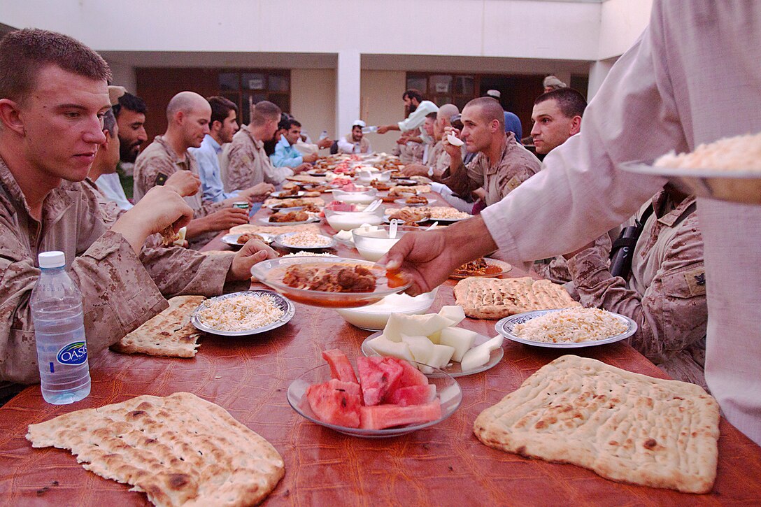 Marines from 1st Battalion, 3rd Marine Regiment and district government officials enjoy Iftar or ‘breaking of fast,’ which is the nightly meal during the month-long Islamic holiday Ramadan, Aug. 8. Marines from 1/3 are regularly invited to Iftar with their Afghan National Army and Police counterparts during Ramadan.