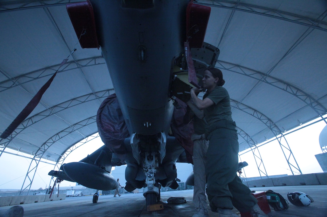 Cpl. Ashley Zifko, a Marine Attack Squadron 513 avionics technician and Two Rivers, Wis., native, installs an inertial navigation unit on one of the AV-8B Harriers on the flightline of Kandahar Airfield, Afghanistan, Aug. 9.