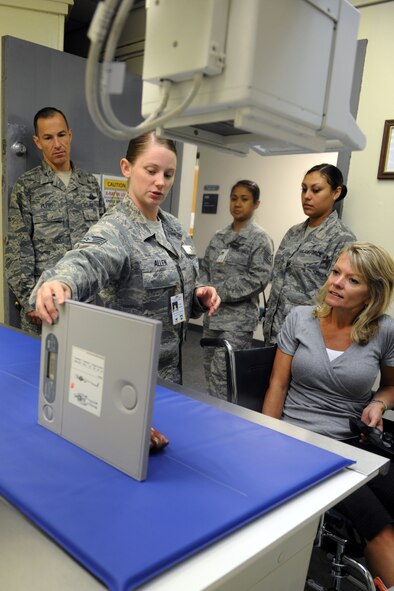 KUNSAN AIR BASE, Republic of Korea -- Tech. Sgt. Tiffany Allen, 8th Medical Support Squadron radiology technician, explains the x-ray process to Col. Scott Pleus, 8th Fighter Wing commander, and his spouse, Jennifer Pleus, during their 8th Medical Group immersion tour here Aug.9. The 8th MDG offers outpatient services including family practice, dental, internal medicine, aerospace medicine, physical therapy and optometry. (U.S. Air Force photo/Senior Airman Brittany Y. Bateman)