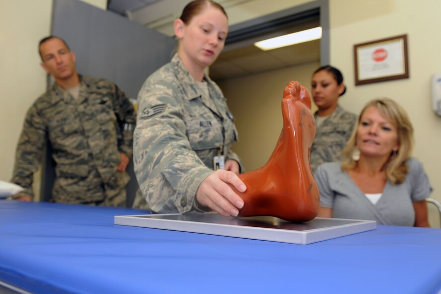 KUNSAN AIR BASE, Republic of Korea -- Tech. Sgt. Tiffany Allen, 8th Medical Support Squadron radiology technician, explains the x-ray process to Col. Scott Pleus, 8th Fighter Wing commander, and his spouse, Jennifer Pleus, during their 8th Medical Group immersion tour here Aug.9. The 8th MDG offers outpatient services including family practice, dental, internal medicine, aerospace medicine, physical therapy and optometry. (U.S. Air Force photo/Senior Airman Brittany Y. Bateman)