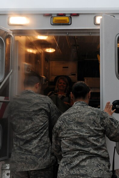 KUNSAN AIR BASE, Republic of Korea -- Mrs. Jennifer Pleus, spouse of Col. Scott Pleus, 8th Fighter Wing commander, is put into an ambulance while participating in a scenario during their 8th Medical Group immersion tour here Aug.9. The group serves a customer population of nearly 3,000 active duty Air Force and Army personnel and a small number of dependants and retirees. (U.S. Air Force photo/Senior Airman Brittany Y. Bateman)