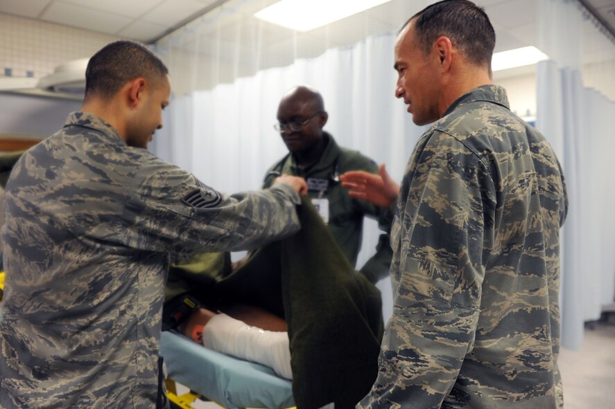 KUNSAN AIR BASE, Republic of Korea -- Col. Scott Pleus, 8th Fighter Wing commander, and his spouse, Jennifer Pleus, participate in a scenario during their 8th Medical Group immersion tour here Aug. 9.  The 8th MDG offers outpatient services including family practice, dental, internal medicine, aerospace medicine, physical therapy and optometry. (U.S. Air Force photo/Senior Airman Brittany Y. Bateman)