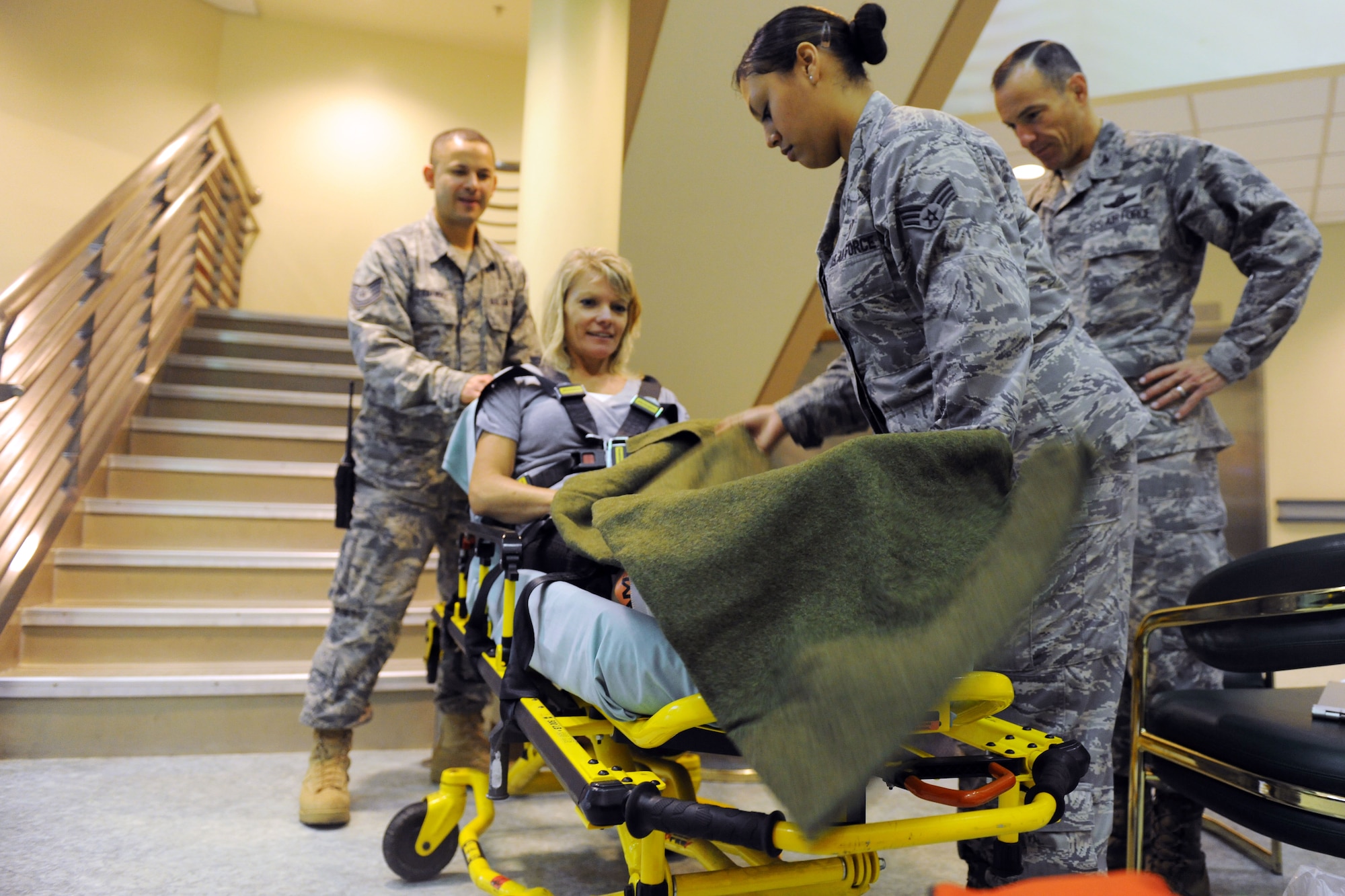KUNSAN AIR BASE, Republic of Korea -- Col. Scott Pleus, 8th Fighter Wing commander, and his spouse, Jennifer Pleus, participate in a scenario during their 8th Medical Group immersion tour here Aug. 9.  The 8th MDG offers outpatient services including family practice, dental, internal medicine, aerospace medicine, physical therapy and optometry. (U.S. Air Force photo/Senior Airman Brittany Y. Bateman)