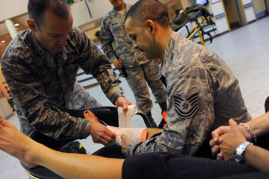 KUNSAN AIR BASE, Republic of Korea -- Col. Scott Pleus, 8th Fighter Wing commander, and his spouse, Jennifer Pleus, participate in a scenario during their 8th Medical Group immersion tour here Aug. 9.  The 8th MDG offers outpatient services including family practice, dental, internal medicine, aerospace medicine, physical therapy and optometry. (U.S. Air Force photo/Senior Airman Brittany Y. Bateman)