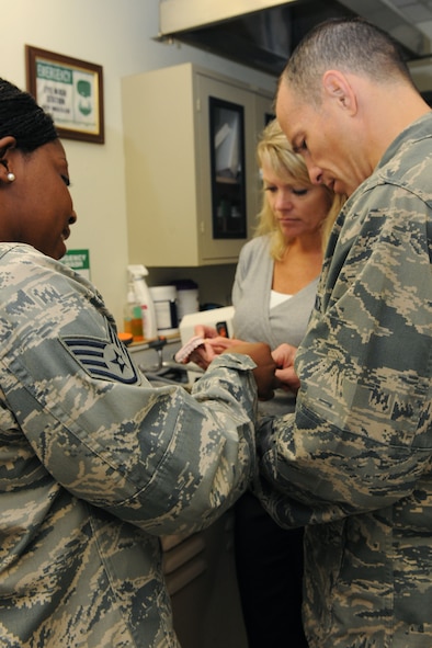 KUNSAN AIR BASE, Republic of Korea -- Col. Scott Pleus, 8th Fighter Wing commander, and his spouse, Jennifer Pleus, get a tour of the dental clinic from Staff Sgt. Dollie Moore, 8th Medical Operations Squadron dental assistant, during their 8th Medical Group Immersion tour, here Aug.9.  The 8th MDG offers outpatient services including family practice, dental, internal medicine, aerospace medicine, physical therapy and optometry. (U.S. Air Force photo/Senior Airman Brittany Y. Bateman) 