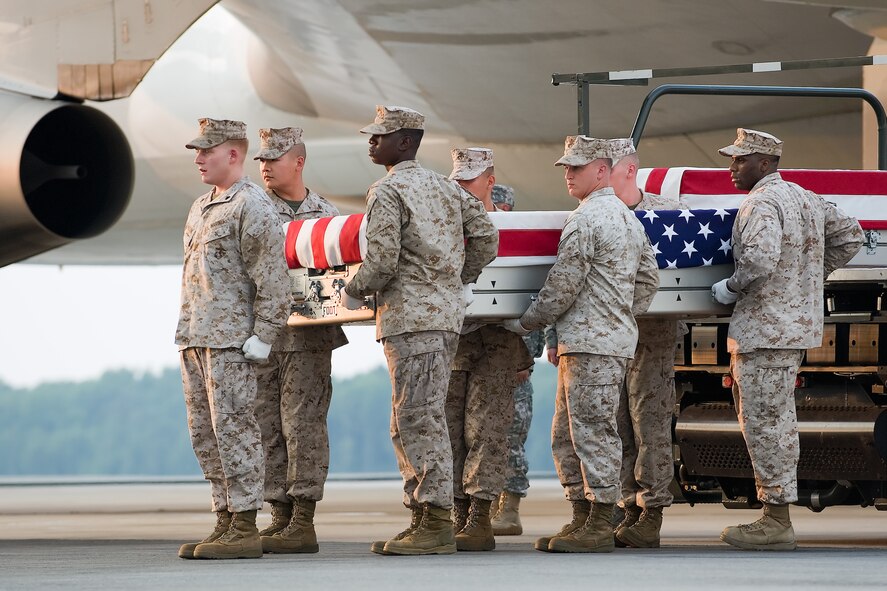 A U.S. Marine Corps carry team transfers the remains of Marine Sgt. Adan Gonzales Jr., of Bakersfield, Calif., at Dover Air Force Base, Del., Aug. 9, 2011. Gonzales was assigned to the 1st Battalion, 5th Marine Regiment, 1st Marine Division, I Marine Expeditionary Force, Camp Pendleton, Calif. (U.S. Air Force photo/Steve Kotecki)