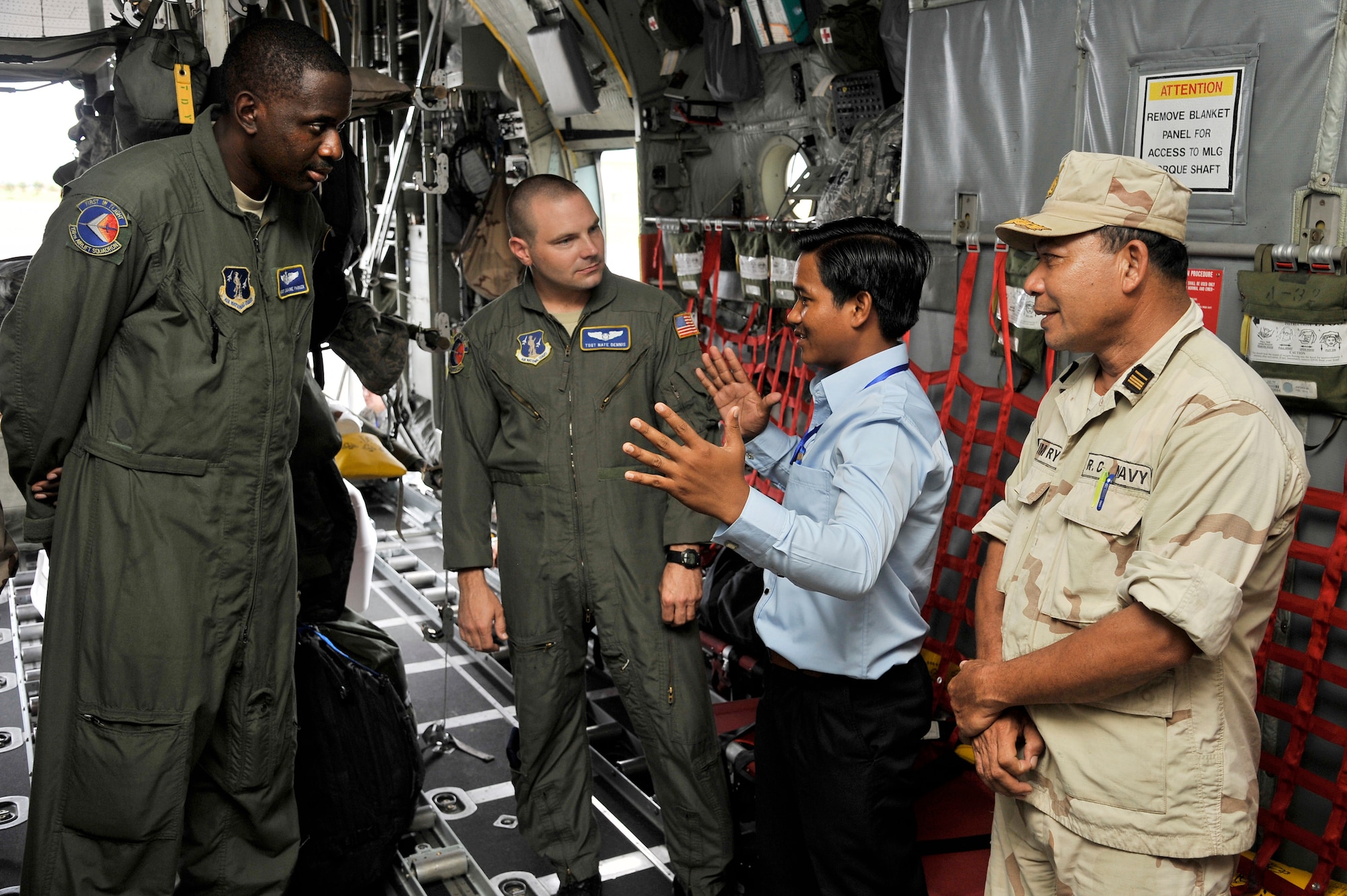 SIHANOUKVILLE, Cambodia – Master Sgt. Jermaine Parker and Tech. Sgt. Nate Dennis explain the cargo area of a C-130H to Royal Cambodian Armed Forces during a subject-matter expert exchange here Aug. 9, 2011. The exchange was part of PACIFIC ANGEL 11-1, an operation which supports U.S. Pacific Command’s capacity-building efforts by partnering with other governments in the region to provide medical, dental, optometry and engineer assistance to their citizens. Sergeant's Parker and Dennis are assigned to the 145th Airlift Wing, Charlotte, N.C. (U.S. Air Force photo/Staff Sgt. Christopher Boitz)