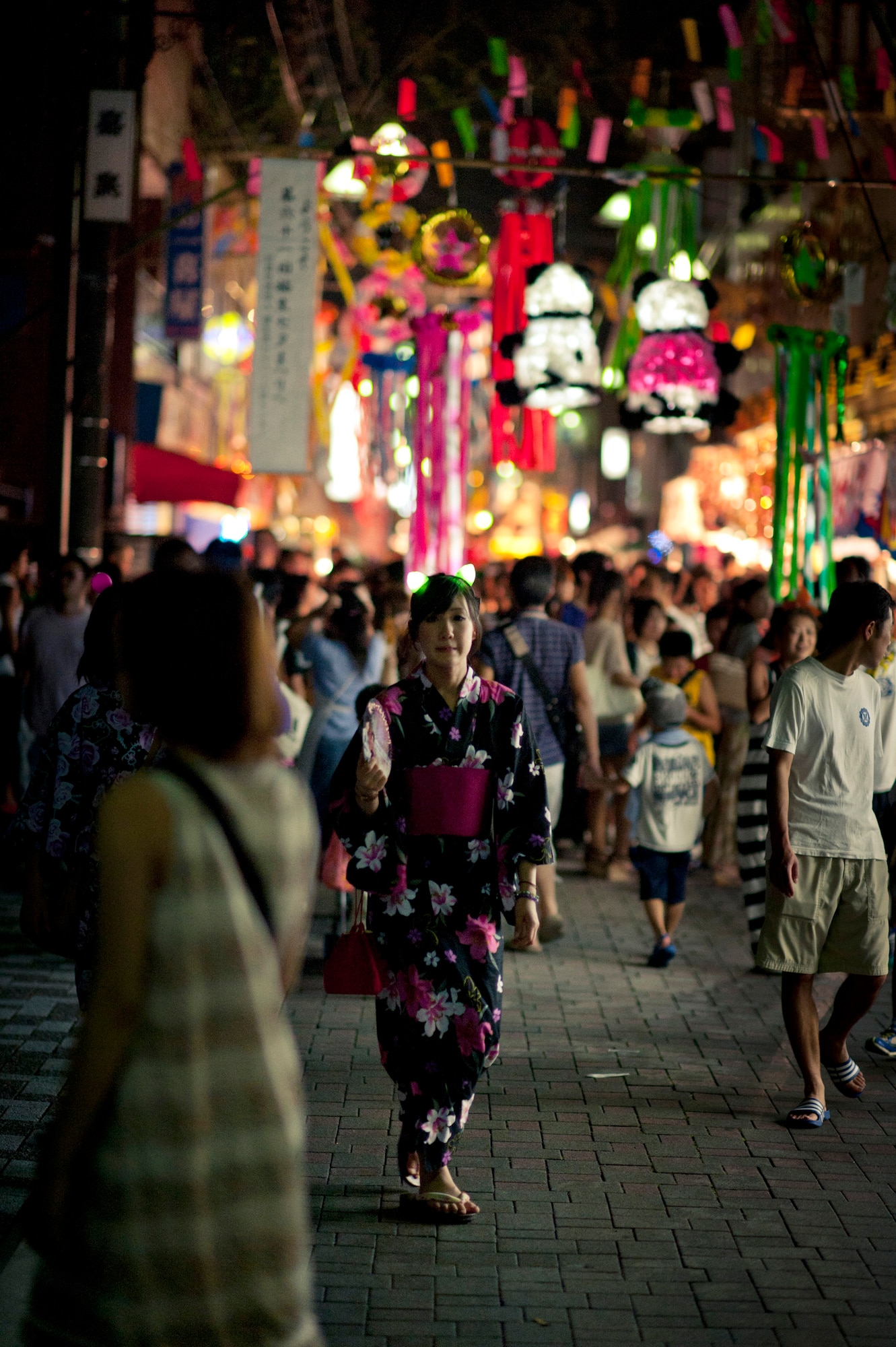 YOKOTA AIR BASE, Japan -- A Japanese woman walks down a side street in Fussa, Japan, wearing a summer kimono, called a yukata, during the Fussa Tanabata Festival Aug. 6, 2011. The festival celebrates the yearly meeting of a mythical prince and princess among the stars. During the evening, community members and visitors eat and drink traditional festival foods such as yakitori, yakisoba, takoyaki and sake. (U.S. Air Force photo/Staff Sgt. Samuel Morse)