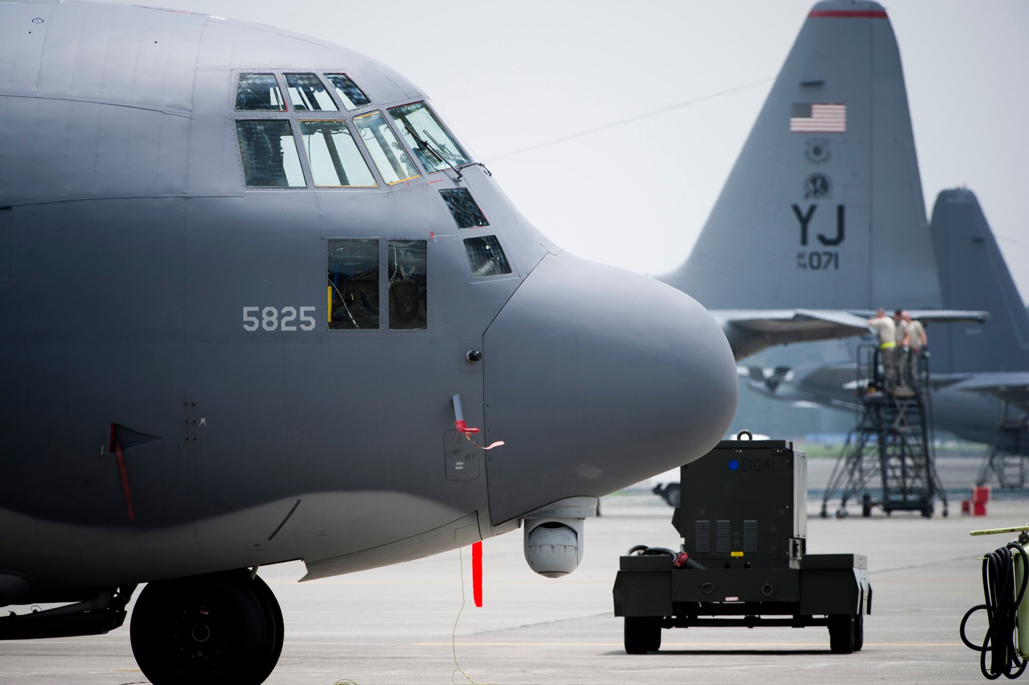 YOKOTA AIR BASE, Japan -- An MC-130P Combat Shadow from Kadena Air Base, Japan, sits parked among Yokota-based C-130 Hercules Aug. 2, 2011, at Yokota Air Base, Japan. The pod below the nose of the MC-130P is a sensor array allowing pilots to navigate inclement weather with minimal assistance from ground-based navigation systems. (U.S. Air Force photo/Staff Sgt. Samuel Morse)