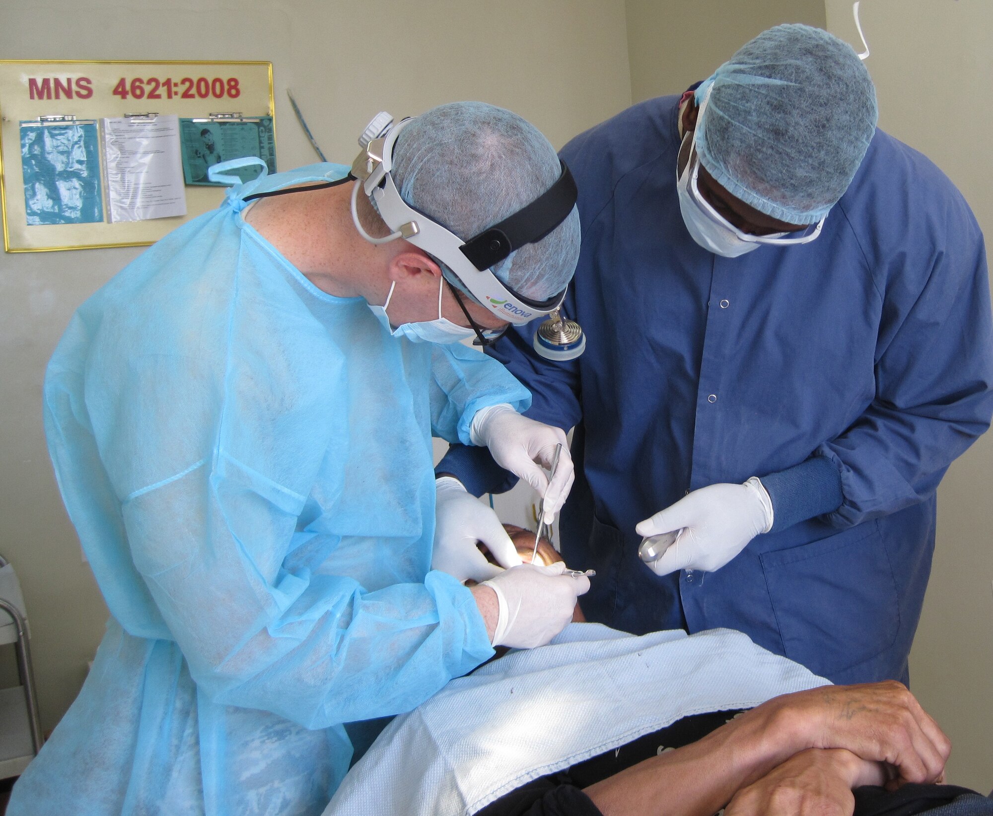 Capt. Ross Yost and a dental assistant perform a dental exam on a patient July 20, 2011, during Operation Pacific Angel 11-4 in Ondorkhaan City, Mongolia. A shortage of supplies meant preventative dental care was often limited to the removal of decaying teeth to prevent infection. Captain Yost, a general dentist, is assigned to the 354th Medical Operation Squadron. (Courtesy photo)        