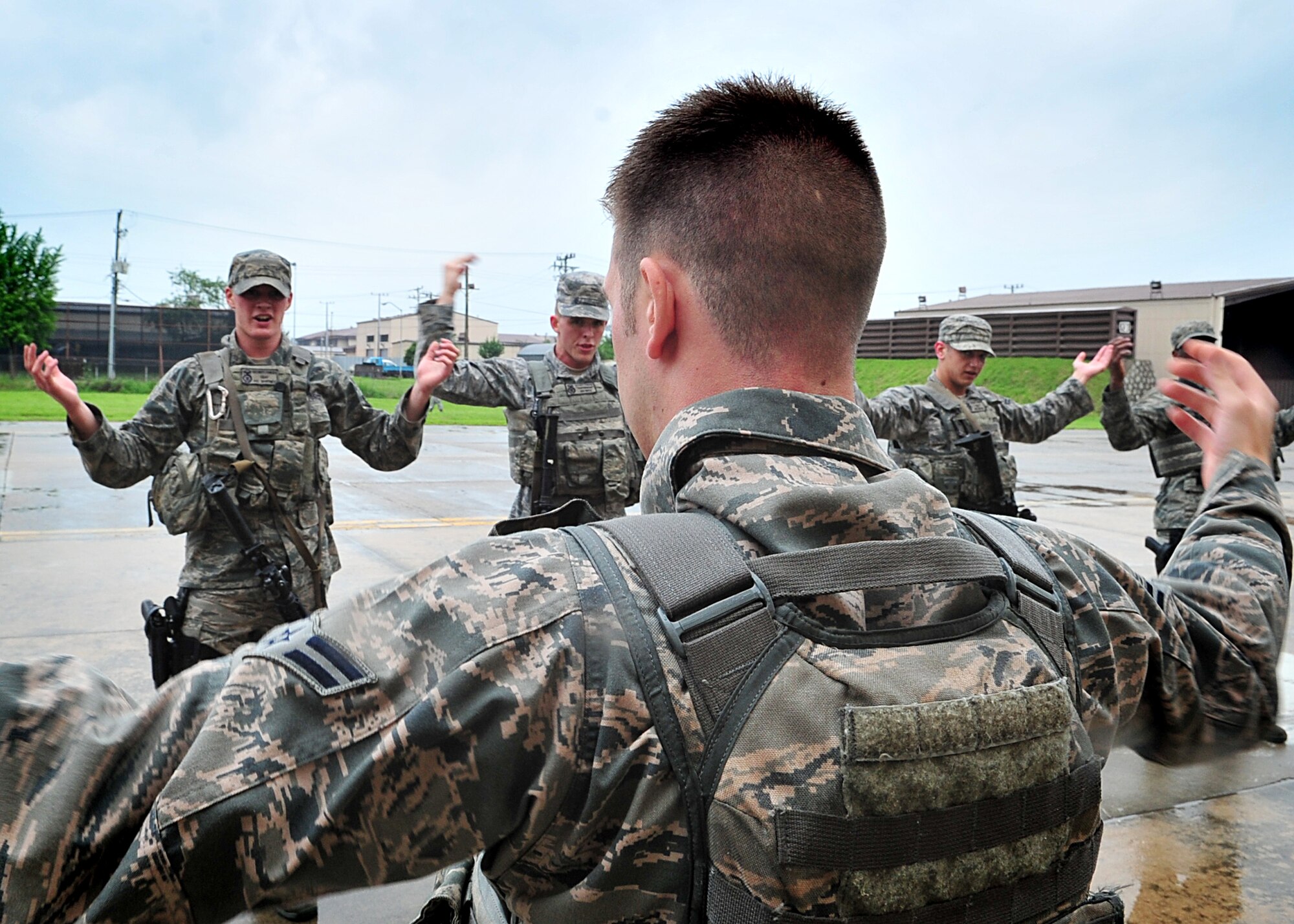 Airmen of the 51st Security Forces endure day zero during the Quick Response Team try-outs here, July 8.  During the intense training, SF members' were challenged both physically and mentally to complete required elements to continue training.  Day zero, also known as ‘smoke day’, 27 Airmen were asked to meet and befriend fatigue performing, 70 pound buddy low and high drags/carries, a 5k with 100 pound log carried as a squad, clearing buildings and tactical troop movements.  Physical training sessions were themed in memory of the 31 warriors lost in Afghanistan, July 7, by each volunteer completing 31 of each exercise throughout the course.   A QRT member provides immediate response to any high risk situation on Osan Air Base to include barricaded suspects, workplace violence, domestic violence and abuse response, school violence, and disaster response.  (U.S. Air Force Photo By/Staff Sgt. Daylena Gonzalez)
*Note: 1 of 4 mini-series
