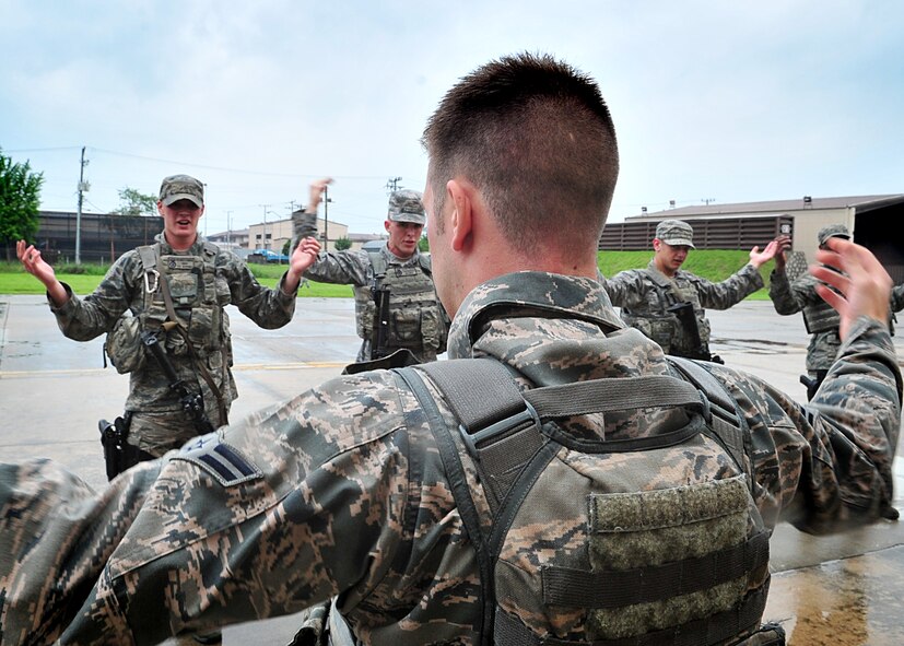 Airmen of the 51st Security Forces endure day zero during the Quick Response Team try-outs here, July 8.  During the intense training, SF members' were challenged both physically and mentally to complete required elements to continue training.  Day zero, also known as ‘smoke day’, 27 Airmen were asked to meet and befriend fatigue performing, 70 pound buddy low and high drags/carries, a 5k with 100 pound log carried as a squad, clearing buildings and tactical troop movements.  Physical training sessions were themed in memory of the 31 warriors lost in Afghanistan, July 7, by each volunteer completing 31 of each exercise throughout the course.   A QRT member provides immediate response to any high risk situation on Osan Air Base to include barricaded suspects, workplace violence, domestic violence and abuse response, school violence, and disaster response.  (U.S. Air Force Photo By/Staff Sgt. Daylena Gonzalez)
*Note: 1 of 4 mini-series

