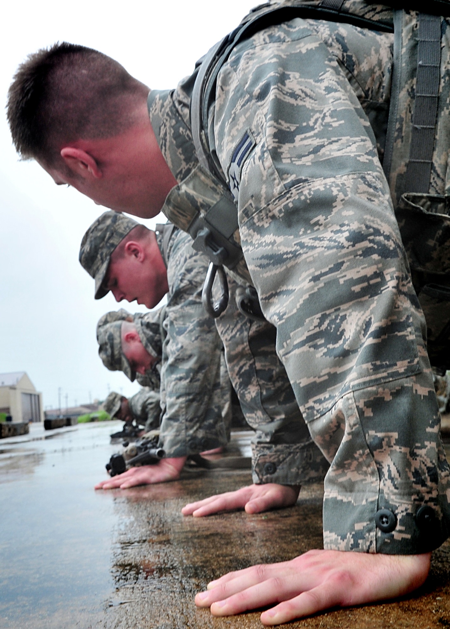 Airmen of the 51st Security Forces endure day zero during the Quick Response Team try-outs here, July 8.  During the intense training, SF members' were challenged both physically and mentally to complete required elements to continue training.  Day zero, also known as ‘smoke day’, 27 Airmen were asked to meet and befriend fatigue performing, 70 pound buddy low and high drags/carries, a 5k with 100 pound log carried as a squad, clearing buildings and tactical troop movements.  Physical training sessions were themed in memory of the 31 warriors lost in Afghanistan, July 7, by each volunteer completing 31 of each exercise throughout the course.   A QRT member provides immediate response to any high risk situation on Osan Air Base to include barricaded suspects, workplace violence, domestic violence and abuse response, school violence, and disaster response.  (U.S. Air Force Photo By/Staff Sgt. Daylena Gonzalez)
*Note: 1 of 4 mini-series

