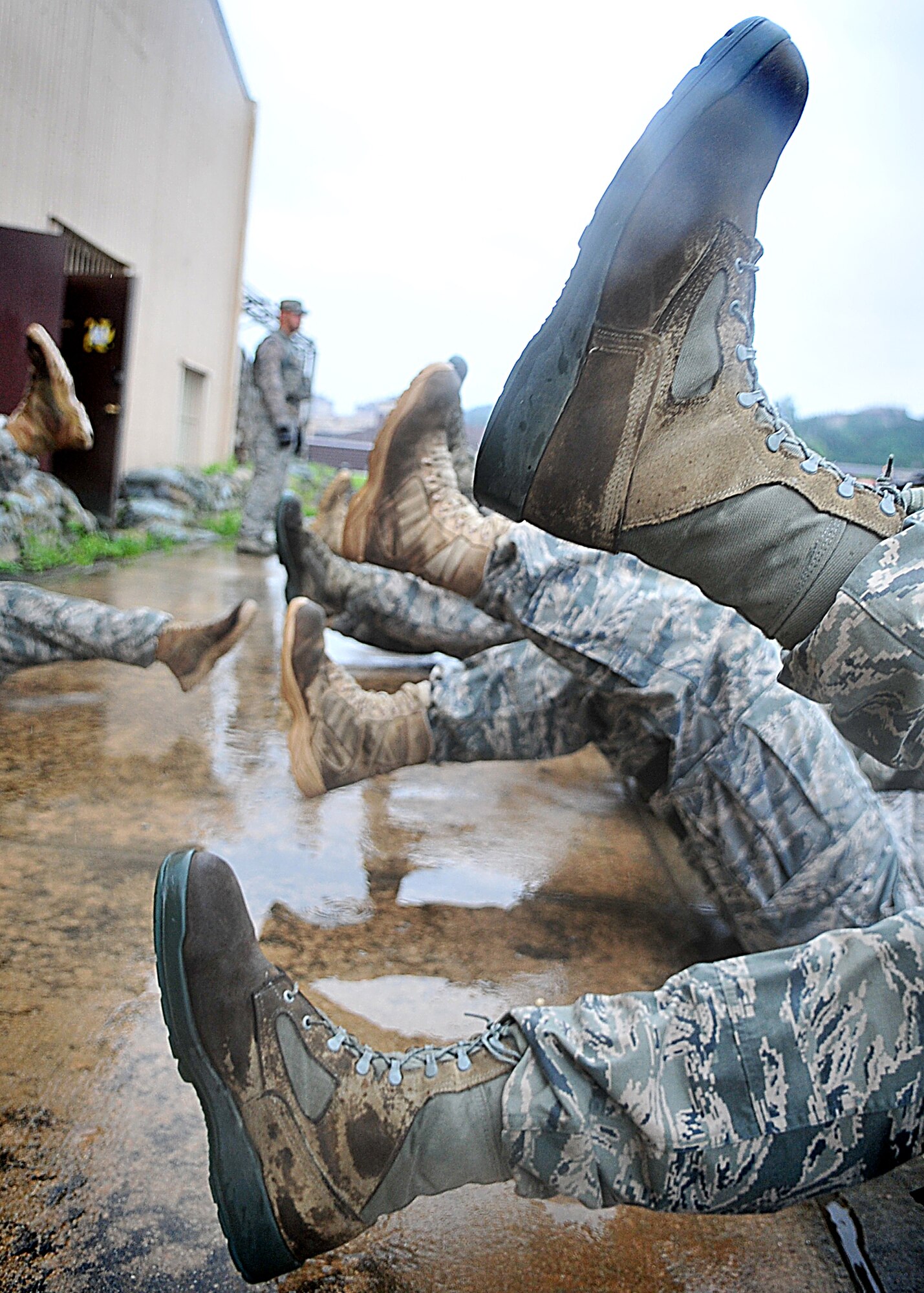 Airmen of the 51st Security Forces endure day zero during the Quick Response Team try-outs here, July 8.  During the intense training, SF members' were challenged both physically and mentally to complete required elements to continue training.  Day zero, also known as ‘smoke day’, 27 Airmen were asked to meet and befriend fatigue performing, 70 pound buddy low and high drags/carries, a 5k with 100 pound log carried as a squad, clearing buildings and tactical troop movements.  Physical training sessions were themed in memory of the 31 warriors lost in Afghanistan, July 7, by each volunteer completing 31 of each exercise throughout the course.   A QRT member provides immediate response to any high risk situation on Osan Air Base to include barricaded suspects, workplace violence, domestic violence and abuse response, school violence, and disaster response.  (U.S. Air Force Photo By/Staff Sgt. Daylena Gonzalez)
*Note: 1 of 4 mini-series
