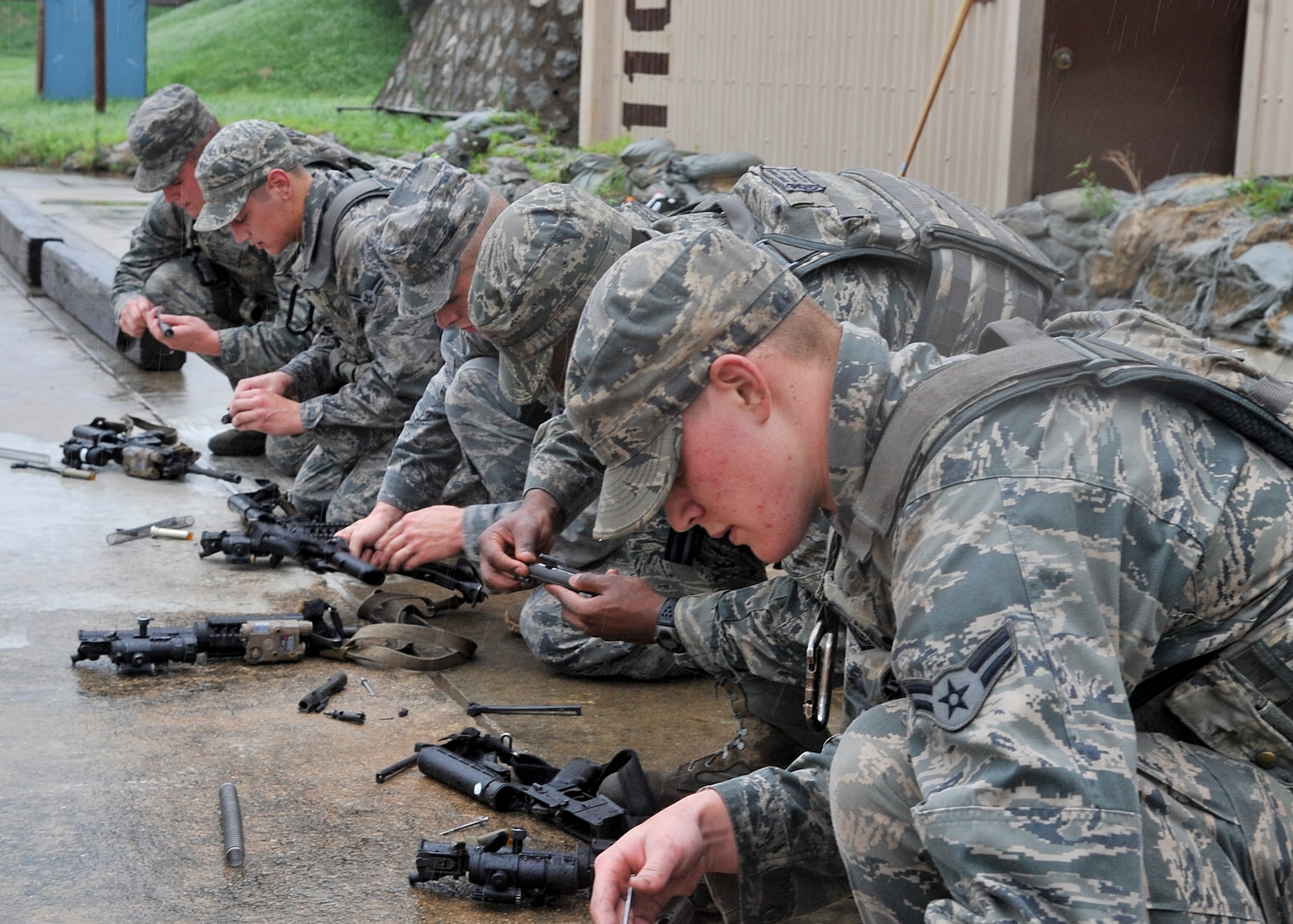 The 51st Security Forces Squadron, held try-outs for the Quick Response Team here, July 8. The purpose of the QRT is to provide an immediate response to any high risk situation on Osan Air Base to include barricaded suspects, workplace violence, domestic violence and abuse response, school violence, and disaster response. During the tryouts Airmen were tested both physically and mentally with the ultimate goal of only selecting the best of the best. The physical aspect of the try-outs consisted of dragging/carrying a 70 pound buddy for 60 yard, calisthenics, building clearing, weapon assembly, 100 pound over head log presses and a 5K as a squad while securing the 100 pound log. During the rigorous try-outs Airmen are pushed to their limits and often loose hand eye coordination, basic motor skills and attention to detail. These factors simulate the effects real world operations were members of the QRT are often under extreme duress. (U.S. Air Force Photos by/ Senior Airman Adam Grant)