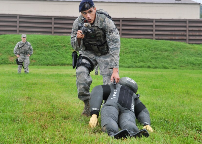 The 51st Security Forces Squadron, held try-outs for the Quick Response Team here, July 8. The purpose of the QRT is to provide an immediate response to any high risk situation on Osan Air Base to include barricaded suspects, workplace violence, domestic violence and abuse response, school violence, and disaster response. During the tryouts Airmen were tested both physically and mentally with the ultimate goal of only selecting the best of the best. The physical aspect of the try-outs consisted of dragging/carrying a 70 pound buddy for 60 yard, calisthenics, building clearing, weapon assembly, 100 pound over head log presses and a 5K as a squad while securing the 100 pound log. During the rigorous try-outs Airmen are pushed to their limits and often loose hand eye coordination, basic motor skills and attention to detail. These factors simulate the effects real world operations were members of the QRT are often under extreme duress. (U.S. Air Force Photos by/ Senior Airman Adam Grant)