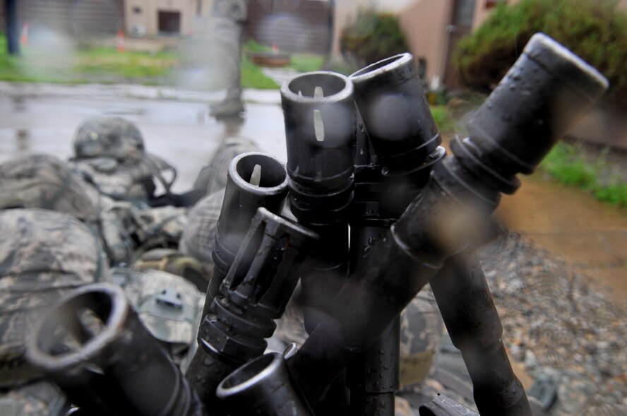 The 51st Security Forces Squadron, held try-outs for the Quick Response Team here, July 8. The purpose of the QRT is to provide an immediate response to any high risk situation on Osan Air Base to include barricaded suspects, workplace violence, domestic violence and abuse response, school violence, and disaster response. During the tryouts Airmen were tested both physically and mentally with the ultimate goal of only selecting the best of the best. The physical aspect of the try-outs consisted of dragging/carrying a 70 pound buddy for 60 yard, calisthenics, building clearing, weapon assembly, 100 pound over head log presses and a 5K as a squad while securing the 100 pound log. During the rigorous try-outs Airmen are pushed to their limits and often loose hand eye coordination, basic motor skills and attention to detail. These factors simulate the effects real world operations were members of the QRT are often under extreme duress. (U.S. Air Force Photos by/ Senior Airman Adam Grant)