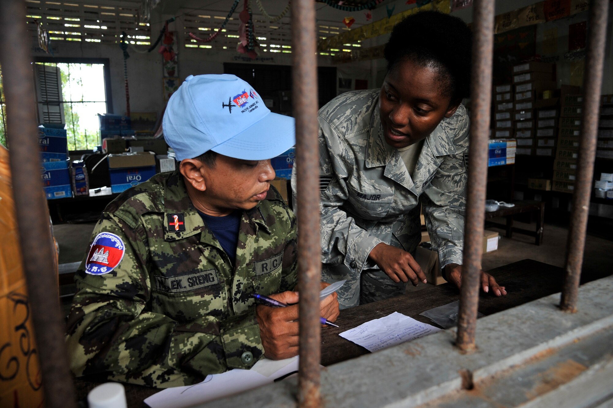 Maj. Ek Sreng and Staff Sgt. Lashawnda Major go over a patients prescription during Cambodia - Operation PACIFIC ANGEL 11-1 Aug. 8, 2011, Bak Klarng, Cambodia. The operation supports U.S. Pacific Command’s capacity-building efforts by partnering with other governments in the region to provide medical, dental, optometry and engineer assistance to their citizens. Major Sreng is a Medic in the Royal Cambodian Armed Forces and Sergeant Major is a pharmacy craftsman assigned to the 36th Medical Group, Andersen Air Force Base, Guam. (U.S. Air Force photo/Staff Sgt. Christopher Boitz)