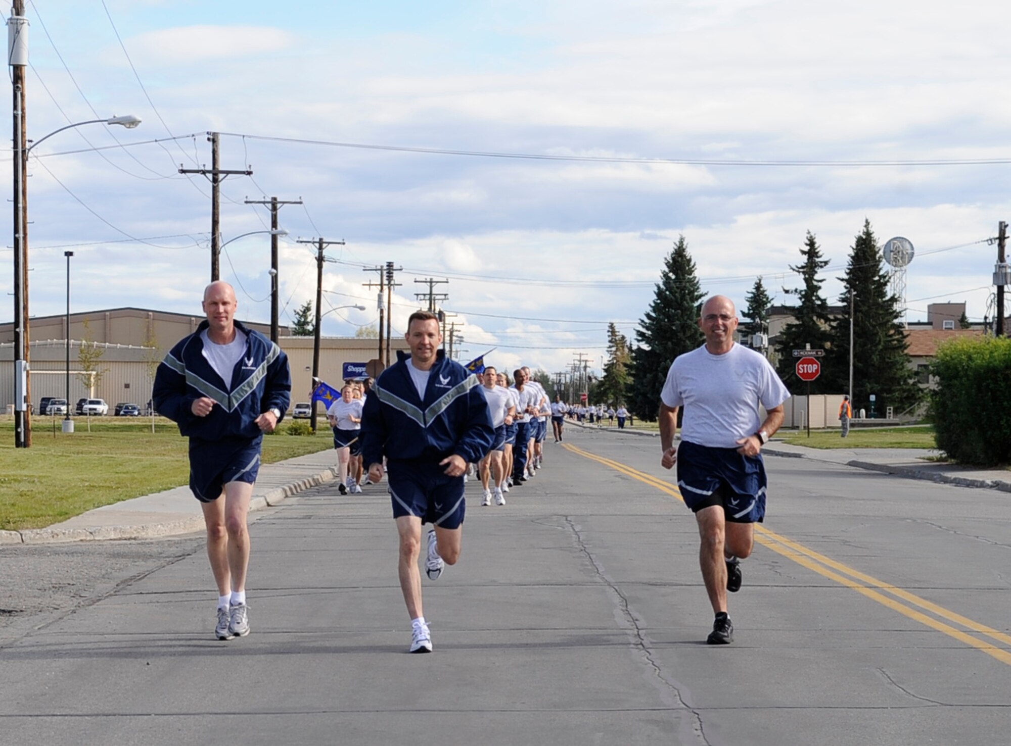 Brig. Gen. James Post III, 354th Fighter Wing commander, Col. Lynn Scheel, 354th FW vice commander, and Chief Master Sgt. Alexander Del Valle, 354th Operations Group superintendent, lead members of the 354th FW in a formation run following a retreat ceremony Aug. 8, 2011, Eielson Air Force Base, Alaska. (U.S. Air Force photo/Staff Sgt. Miguel Lara III)