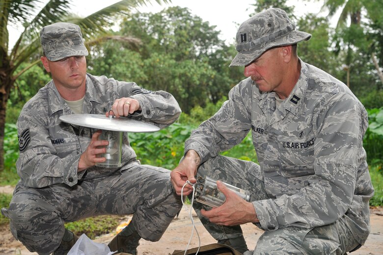 Tech. Sgt. Russ Thomas and Capt. Wes Walker put together traps for mosquitoes associated with malaria and dengue in a rural part of Cambodia Aug. 6, 2011, during Operation PACIFIC ANGEL 11-1. According to the Centers for Disease Control and Prevention, Cambodia had 57,232 reported cases of malaria from 2000 to 2005; cases climbed to 64,595 in 2009. Walker, an entomologist, and Thomas, a public health technician, are both assigned to Kadena Air Base, Japan. (U.S. Air photo/Staff Sgt. Christopher Boitz)