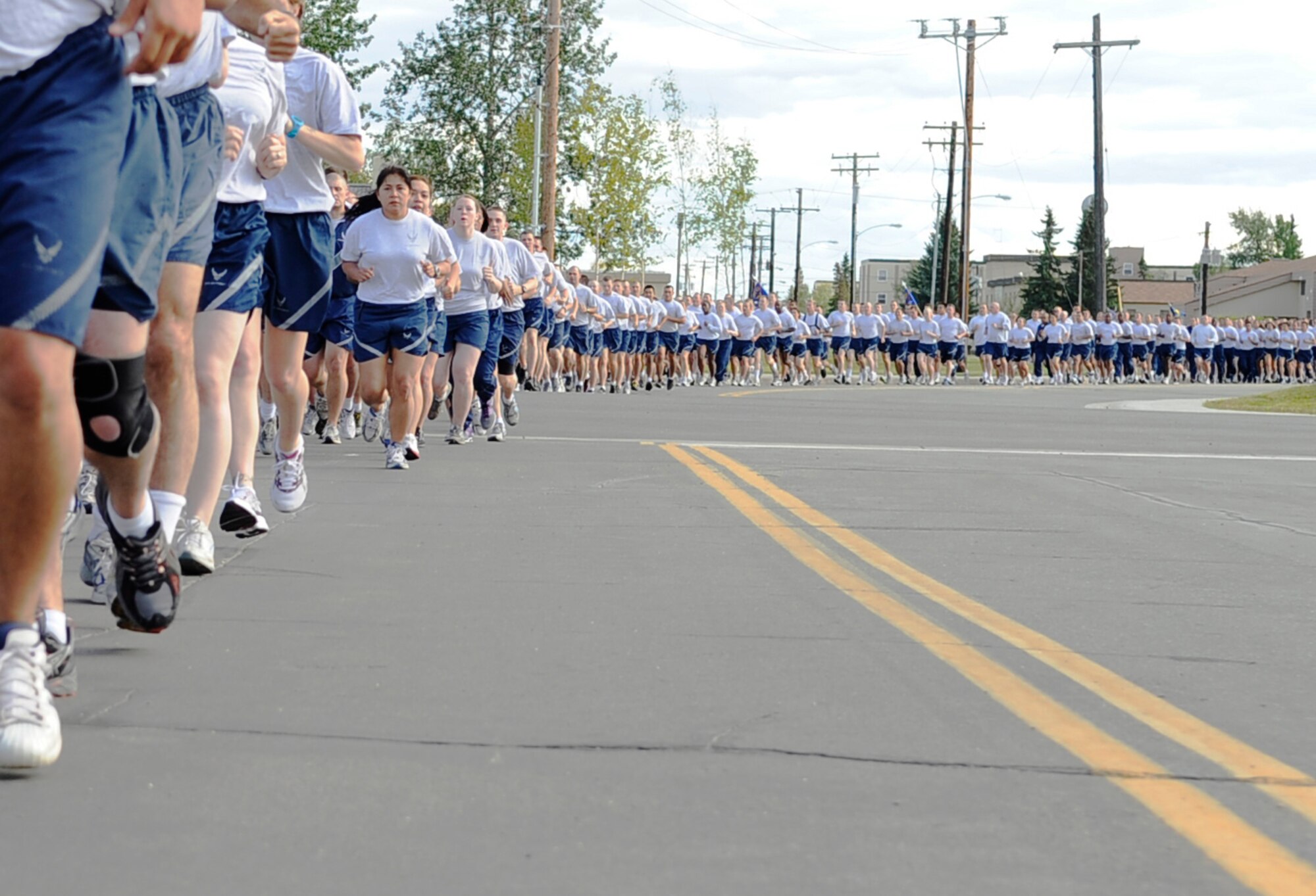 Eielson Airmen run in formation during a 5K Aug. 8, 2011, Eielson Air Force Base, Alaska. Members of the 354th Fighter Wing participated in the run after a retreat ceremony in front of Amber Hall. (U.S. Air Force photo/Staff Sgt. Miguel Lara III)
