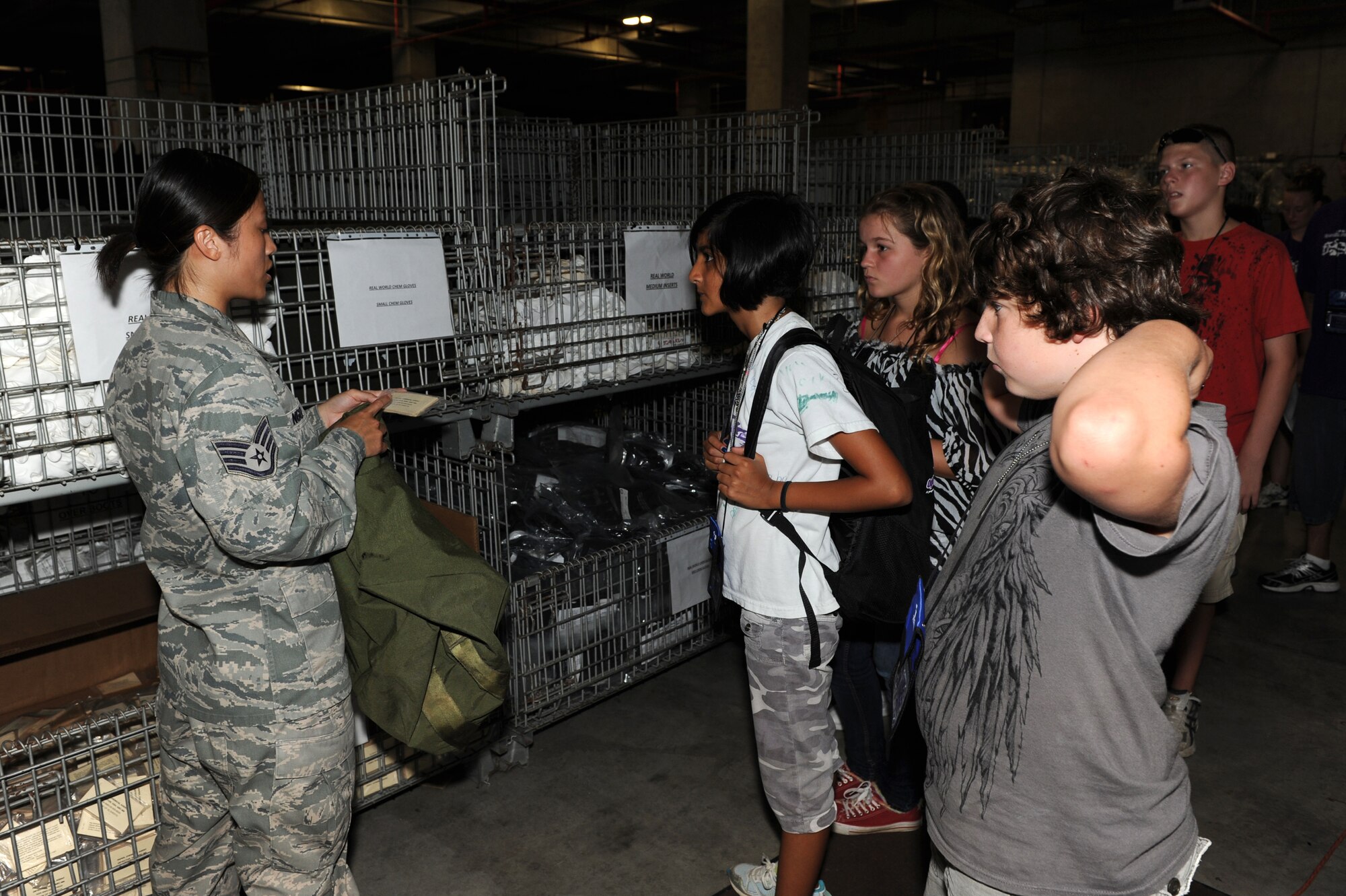 Staff Sgt. Duong Ngo, 18th Logistics Readiness Squadron technician, shows M-8 chemical paper to participants experiencing a mock deployment Aug. 1 at Kadena Air Base, Japan, during Operation Purple Camp. Children of U.S. military service members and Department of Defense personnel participated in demonstrations and briefings to illustrate how the deployment process works. Workers from the 18th Force Support Squadron also worked with participants to make Operation Purple Camp a success. (U.S. Air Force photo/Junko Kinjo)