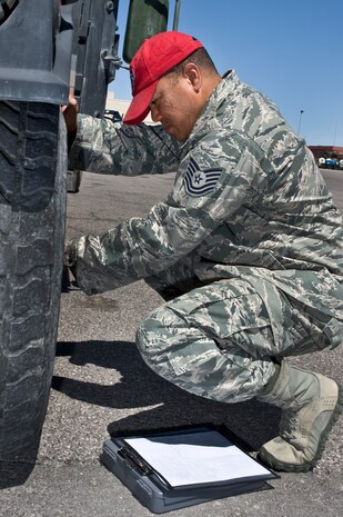 U.S. Air Force Tech. Sgt. Tetsuo Douglas, 820th RED HORSE Squadron NCO in charge of vehicle management and analysis, examines the tire of a Humvee Aug. 4, 2011, at Nellis Air Force Base, Nev.  Douglas is in charge of managing, tracking and controlling more than 280 vehicles for the RED HORSE squadron.  RED HORSE is a highly deployable unit that relies on the upkeep and management of its mobile fleet. (U.S. Air Force photo by Airman 1st Class Matthew Lancaster/Released)