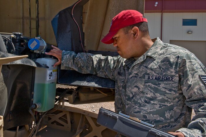 U.S. Air Force Tech. Sgt. Tetsuo Douglas, 820th RED HORSE Squadron NCO in charge of vehicle management and analysis, checks the fluids of a mine-resistant ambush-protected vehicle Aug. 4, 2011, at Nellis Air Force Base, Nev.  Douglas is in charge of managing, tracking and controlling more than 280 vehicles for the RED HORSE squadron.  RED HORSE is a highly deployable unit that relies on the upkeep and management of its mobile fleet. (U.S. Air Force photo by Airman 1st Class Matthew Lancaster/Released)