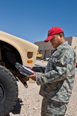 U.S. Air Force Tech. Sgt. Tetsuo Douglas, 820th RED HORSE Squadron NCO in charge of vehicle management and analysis, examines the tire of a Humvee Aug. 4, 2011, at Nellis Air Force Base, Nev.  Douglas is in charge of managing, tracking and controlling more than 280 vehicles for the RED HORSE squadron.  RED HORSE is a highly deployable unit that relies on the upkeep and management of its mobile fleet. (U.S. Air Force photo by Airman 1st Class Matthew Lancaster/Released)