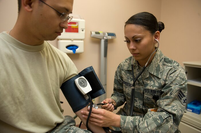 U.S. Air Force Senior Airman Ulla Stromberg, 99th Inpatient Operations Squadron aerospace medical technician, takes the blood pressure of Airman 1st Class Matthew Lancaster, 99th Air Base Wing photographer, April 4, 2011, at Mike O'Callaghan Federal Hospital at Nellis Air Force Base, Nev. Stromberg was recently named one of the Air Forces' 12 Outstanding Airmen of the Year. The Outstanding Airman of the Year Ribbon is awarded to 12 enlisted Airmen who display superior leadership, job performance, community involvement and personal achievements throughout the year. Air Force Association officials will honor the 12 recipients September 2011 during the Air and Space Conference and Technology Exposition in Washington, D.C. (U.S. Air Force photo by Senior Airman Stephanie Rubi/Released)