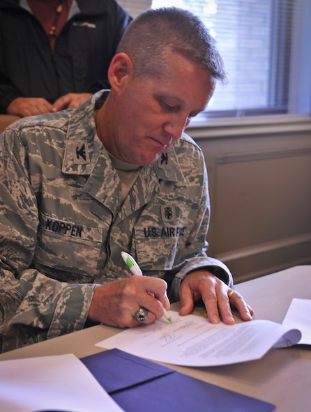 U.S. Air Force Col. Mark Koppen, 23rd Medical Group commander, signs a document that allows WTC students to complete the clinical portion of their curriculum by working at the 23rd MDG facility on Moody Air Force Base, Ga. during a ceremony at WTC, Valdosta, Ga., Aug. 9, 2011. Students will rotate through five sections every three weeks during the semester. (U.S. Air Force by Airman 1st Class Joshua Green/Released)
