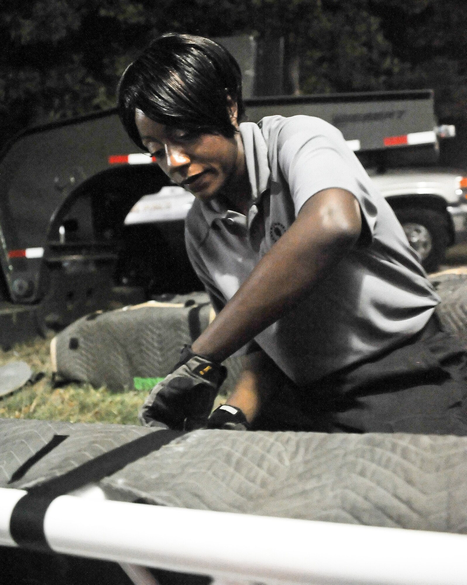 Staff Sgt. Rosalyn Moody, a vocalist with Tops in Blue, tapes up stage equipment Aug. 7, 2011, at Delaware State University at Dover, Del. Tops in Blue members set up and tear down their own equipment. (U.S. Air Force photo by Airman 1st Class Samuel Taylor)