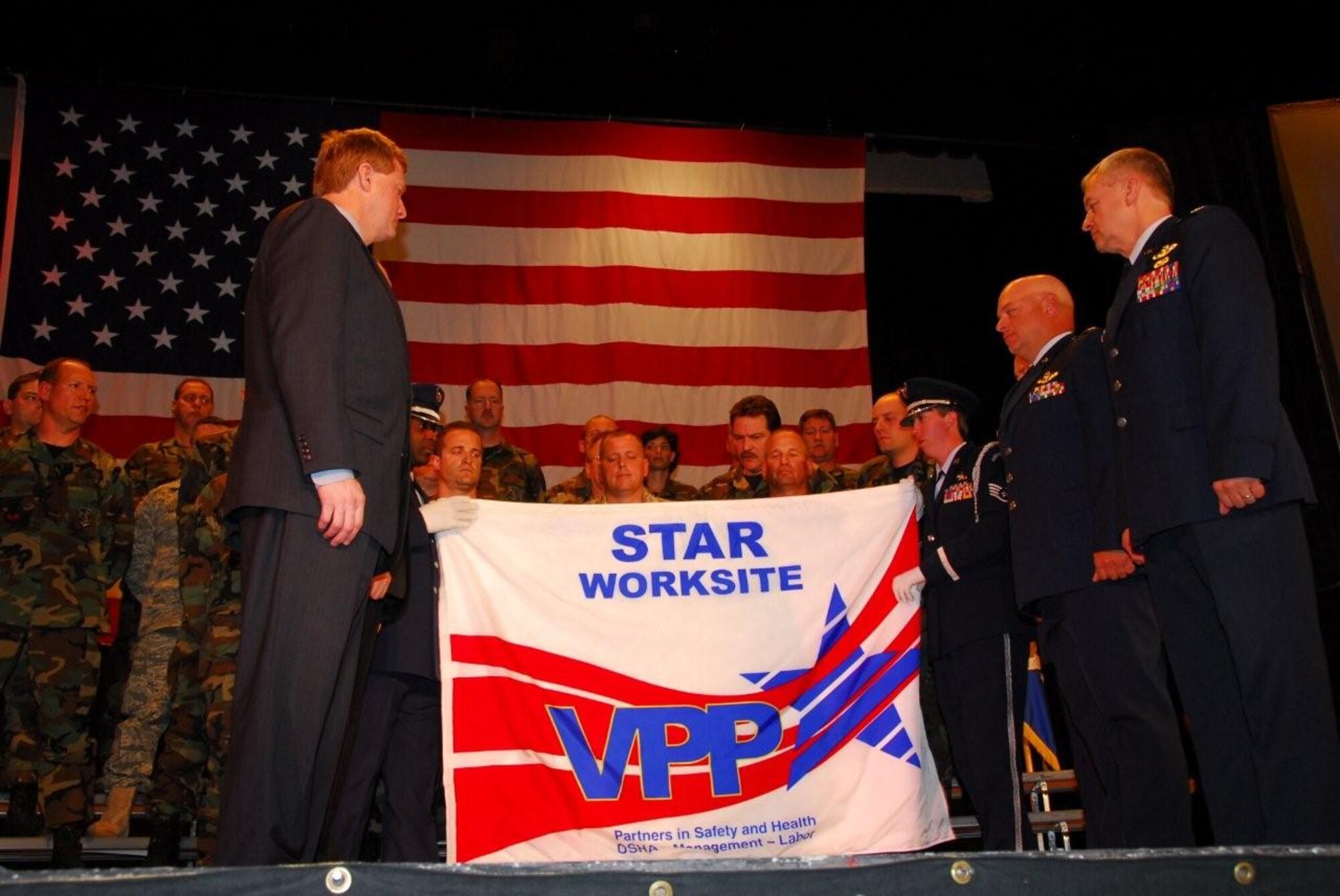 The official OSHA VPP Star Rating flag is presented at
an awards ceremony in June 2008.  That flag is displayed proudly at the
148th Fighter Wing.
