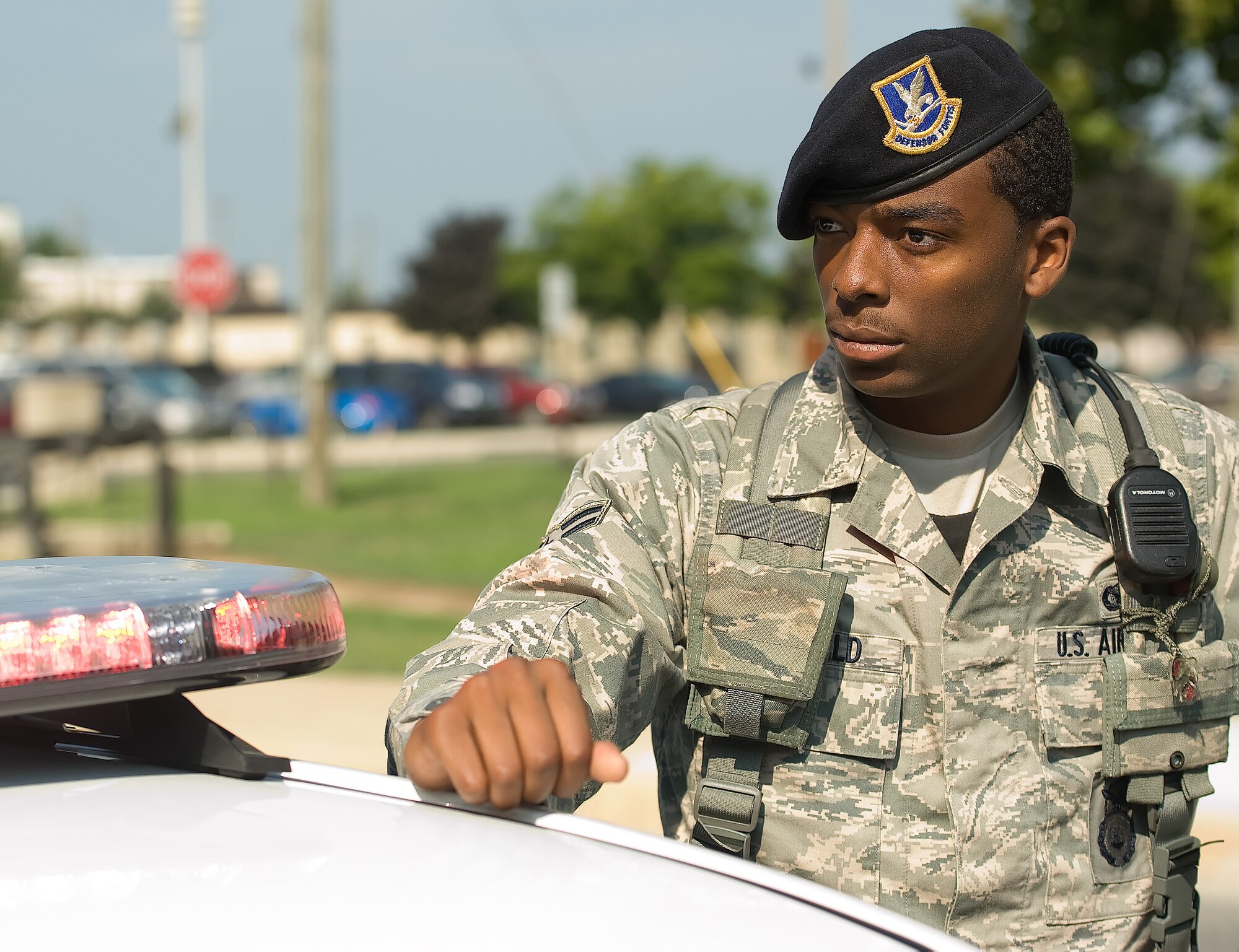 Airman 1st Class Moses McDonald, a patrolman with the 436th Security Forces Squadron, gets out of his patrol car to issue a warning to a driver for failure to stop Aug. 8, 2011, at Dover Air Force Base, Del. Patrolmen from the 436 SFS are responsible for security of the base as well as law enforcement. (U.S. Air Force photo by Airman 1st Class Jacob Morgan)