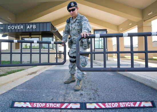Airman 1st Class Joseph McGuire, a patrolman with the 436th Security Forces Squadron, closes the North Gate Aug. 8, 2011, at Dover Air Force Base, Del. Patrolmen from the 436 SFS are responsible for security of the base as well as law enforcement. (U.S. Air Force photo by Airman 1st Class Jacob Morgan)