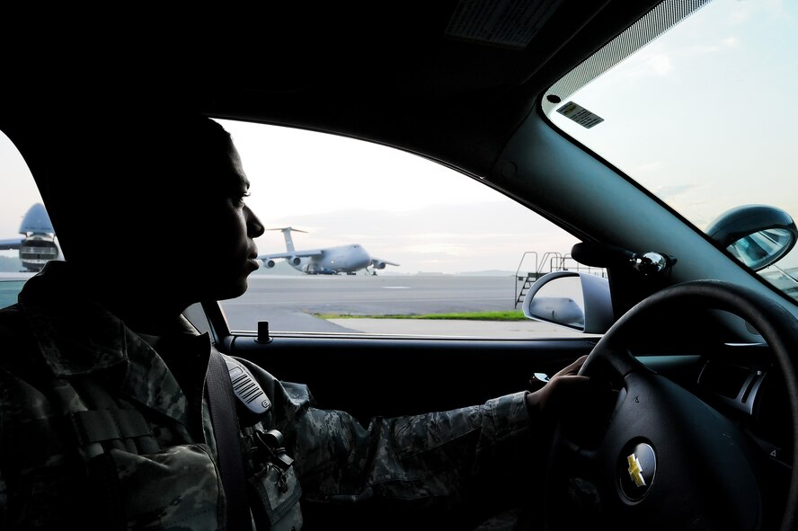 Airman 1st Class Moses McDonald, a patrolman with the 436th Security Forces Squadron, watches the flightline while on patrol Aug. 8, 2011, at Dover Air Force Base, Del. Patrolmen from the 436 SFS are responsible for security of the base as well as law enforcement. (U.S. Air Force photo by Airman 1st Class Jacob Morgan)