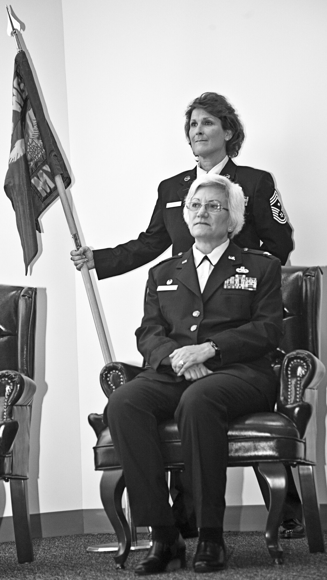 Col. Anna Schulte is poised and ready to assume command of the 403rd Maintenance Group Aug. 6, while Chief Master Sgt. Shiela Richard, 403rd MXG first sergeant, stands by to present the group's guidon. (U.S. Air Force Photo by Maj. Heather Newcomb)