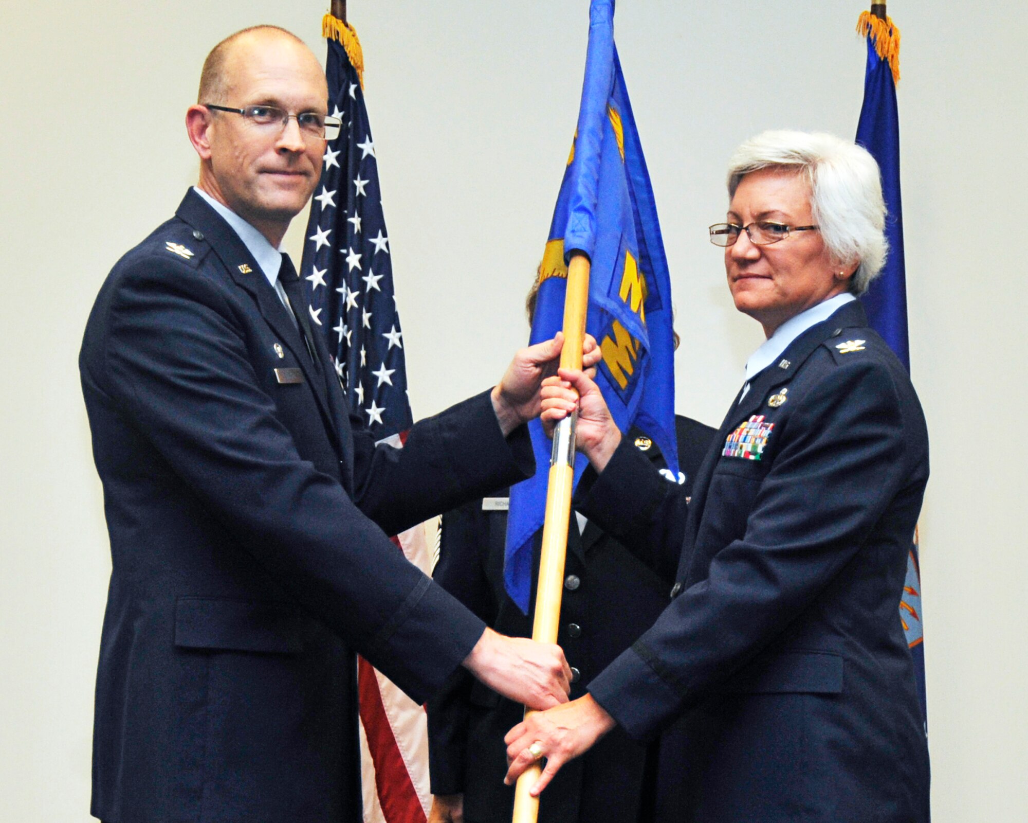 Col. Anna Schulte assumes command of the 403rd Wing Maintenance Group from Col. Jay Jensen, 403rd Wing commander, Aug. 6. (U.S. Air Force Photo by Maj. Heather Newcomb)