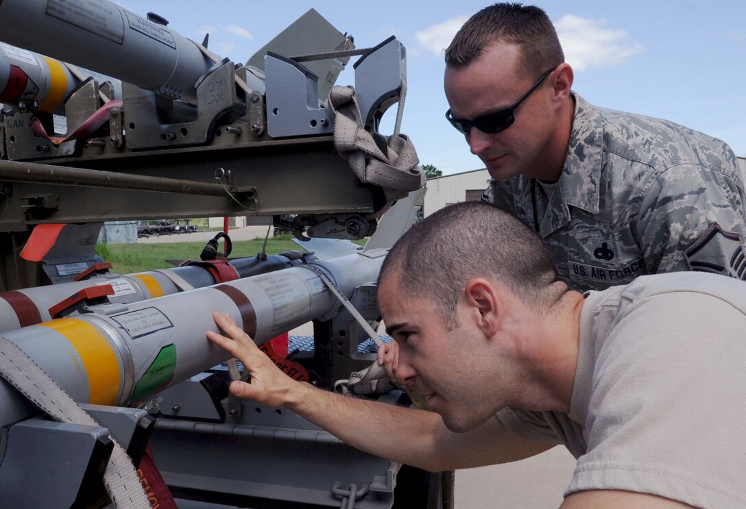Staff Sgt. James Cote, 1st Maintenance Squadron precision guided ammunitions supervisor, and Master Sgt. William Todd, 633rd Air Base Wing weapons safety manager, inspect an  Air Intercept Missile-9 during a spot inspection at Langley Air Force Base, Va., July 14, 2011. The safety office’s primary functions are aiding the commander in determining if their personnel work in a safe and healthful environment, follow safe work practices and comply with safety standards.  (U.S. Air Force photo by Airman 1st Class Racheal Watson/Released)