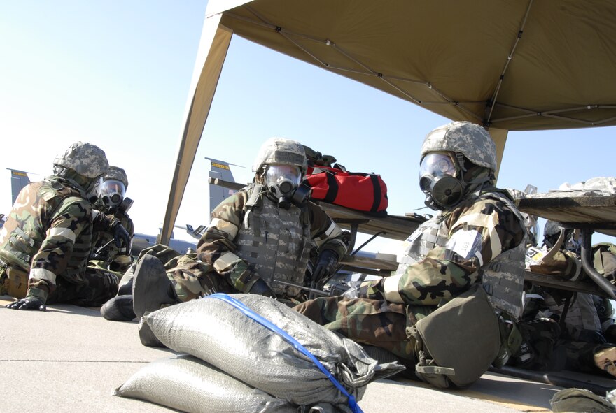 Senior Master Sergeant Michael Haafke and Technical Sergeant Robert Phipps, of the 185th Air Refueling Wing, Sioux City, Iowa Air National Guard Vehicle Maintenance, wait for the “all clear” before going back to work during an ORI on 9 August, 2011.