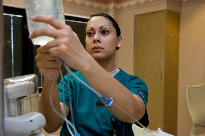 U.S. Air Force Senior Airman Ulla Stromberg, 99th Inpatient Operations Squadron aerospace medical technician, hangs an intravenous bag April 4, 2011, at Mike O'Callaghan Federal Hospital at Nellis Air Force Base, Nev. Stromberg was recently named one of the Air Forces' 12 Outstanding Airmen of the Year. The Outstanding Airman of the Year Ribbon is awarded to 12 enlisted Airmen who display superior leadership, job performance, community involvement and personal achievements throughout the year. Air Force Association officials will honor the 12 recipients September 2011 during the Air and Space Conference and Technology Exposition in Washington, D.C. (U.S. Air Force photo by Airman 1st Class Matthew Lancaster/Released)