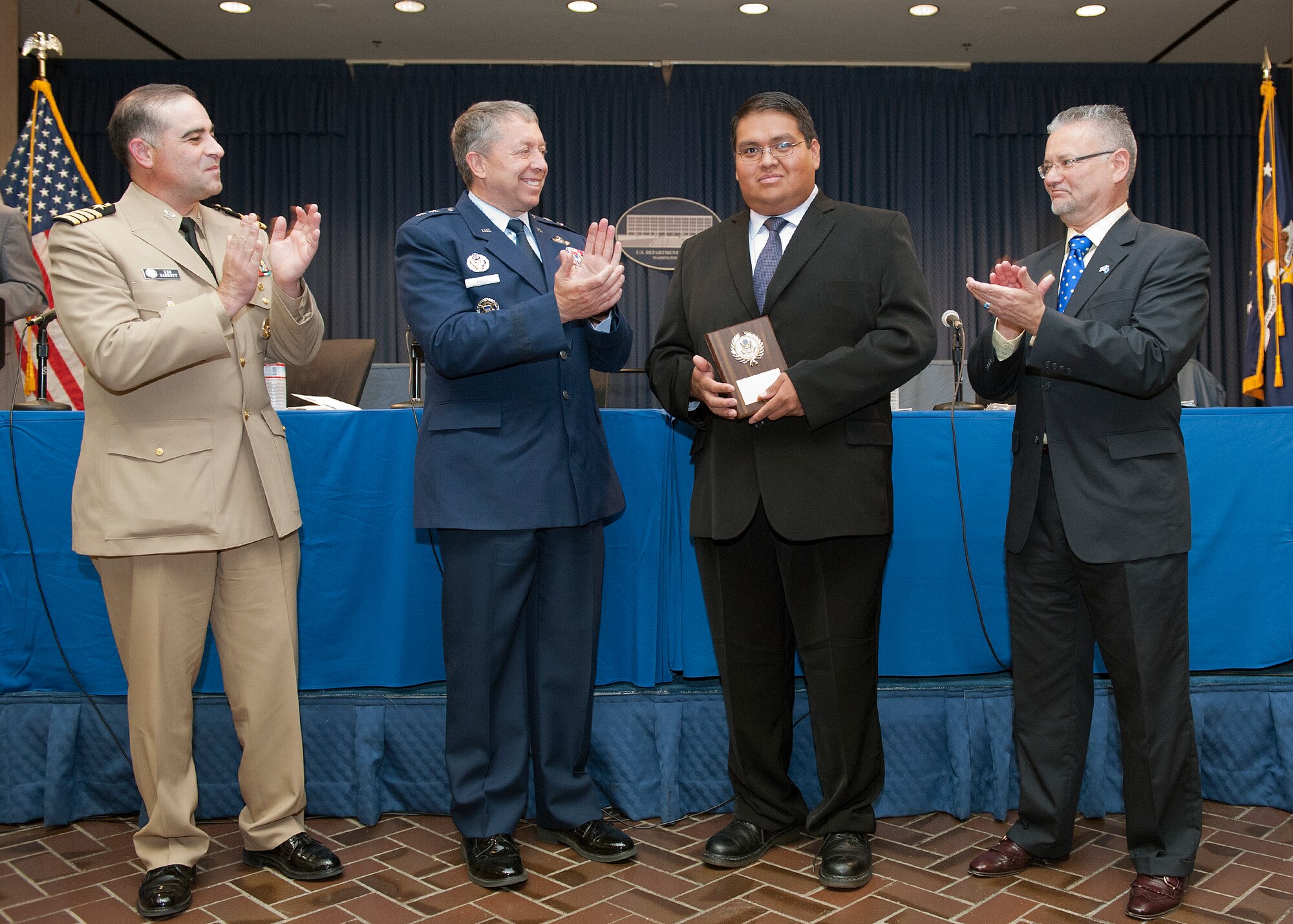 Flanked by Navy Capt. Kenneth Barrett (left) and Gene Sexton (right), Maj. Gen. Gregory Feest, the Air Force chief of safety and commander of the Air Force Safety Center at Kirtland Air Force Base, N.M., congratulates Michael Nakai for being one of five recipients of the 2011 Judith C. Gilliom Outstanding Workforce Recruitment Program for College Students with Disabilities Award during a ceremony Aug. 5, 2011, at the Department of Labor headquarters in Washington, D.C.  Nakai is an information technology specialist at the safety center. Barrett is the deputy director of the office of diversity management and equal opportunity for DOD.  Sexton is the director of the human resources center for the DOL.  (U.S. Air Force photo/Jim Varhegyi)